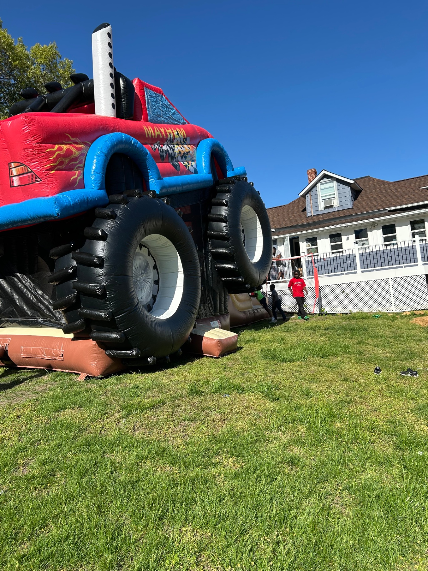 Monster truck bounce house with kids playing